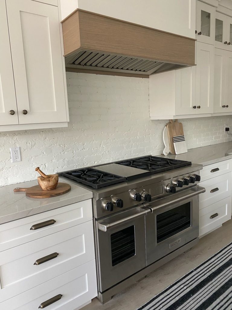 White painted brick kitchen backsplash